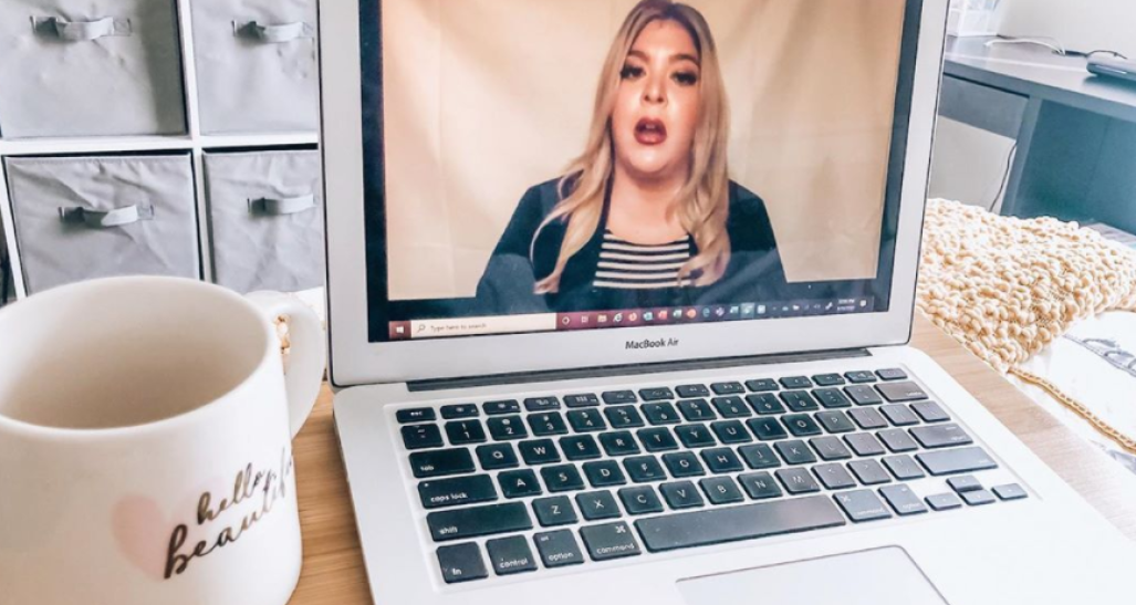 Laptop computer with full screen of female speaking