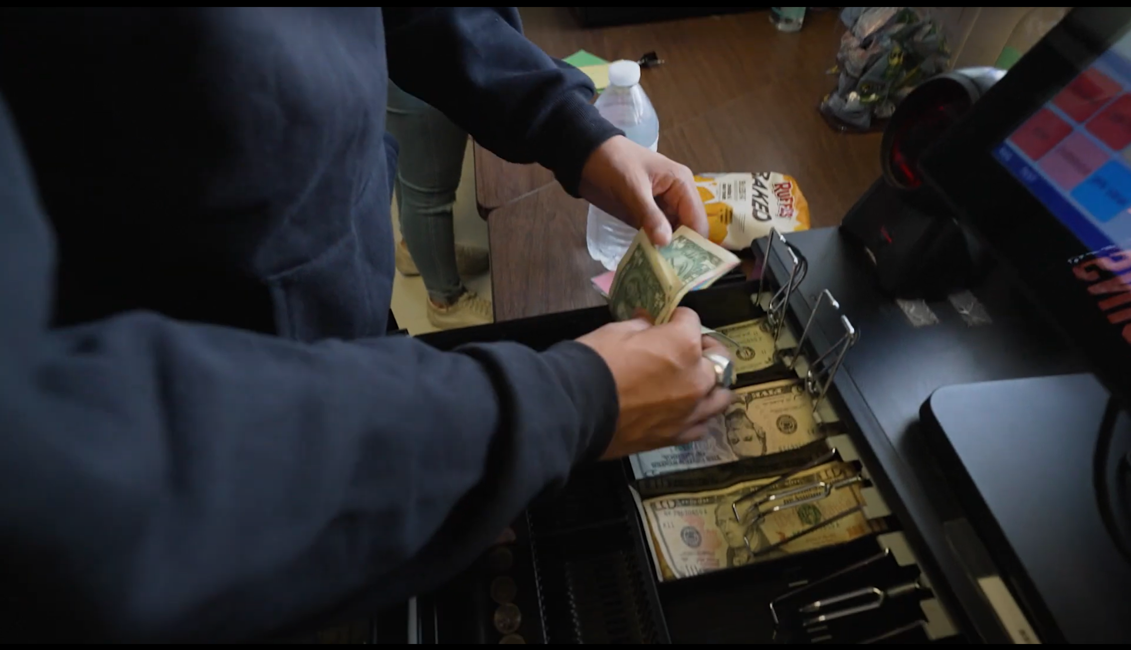 cash register with dollar bills